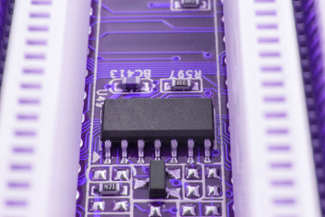 Chip on motherboard mainboard with controllers, ports and wires, close-up macro toned