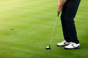 Fototapeta na wymiar Golfer preparing for a putt on the green.