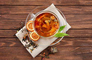 Cup of tea on wooden background, top view