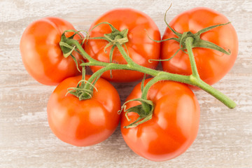 Tomatoes on a white wooden background close up.