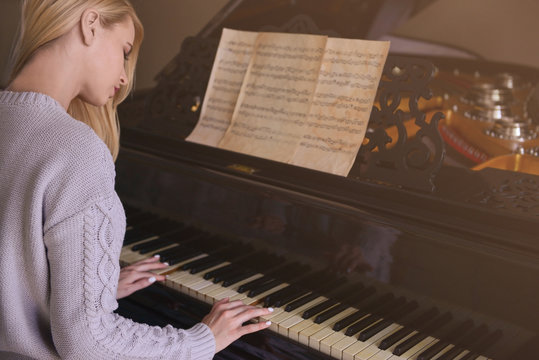 Beautiful girl playing piano