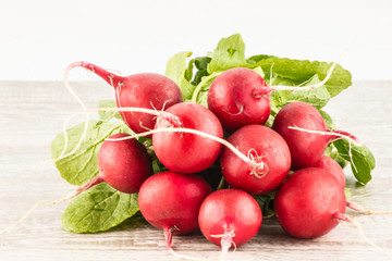 Radish on a white wooden background close up.
