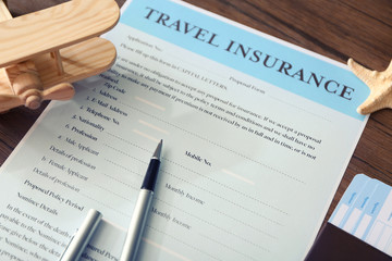 Pen on blank travel insurance form, closeup
