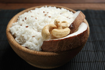 Tasty coconut rice with cashew nuts on bamboo mat