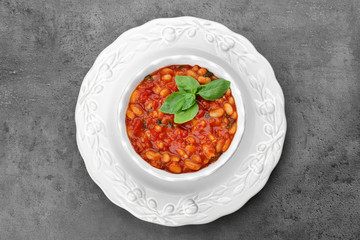 Beautiful dinnerware with delicious Italian butter beans on grey background
