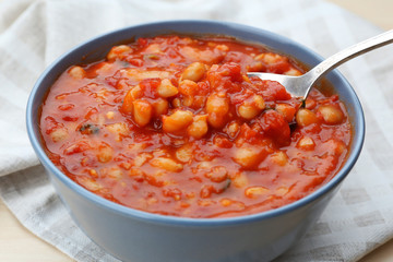 Bowl with delicious Italian butter beans on napkin, close up