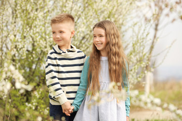 Fototapeta premium Pretty little girl and cute boy walking in spring park
