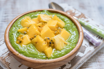 Green smoothie bowl with fruits and kale