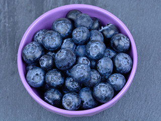 Bowl with blueberry on slate