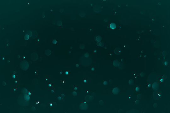 Bokeh Background Very dark (mostly black) cyan.