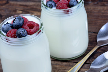 Yogurt with berries in a jars glass