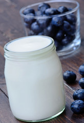 Yogurt and blueberry on table