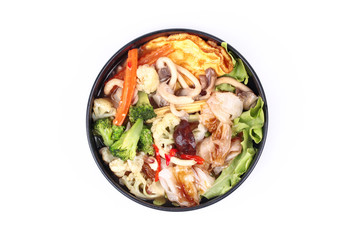 Fried big noodle  with omelet topped mixed vegetable in soup.