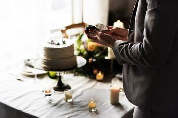 Man Hands Holding Wedding Cup Cake on Reception Banquet