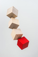 Business concept - Abstract geometric real floating wooden cube on grey background and it's not 3D render. the symbol of leadership, teamwork and growth.