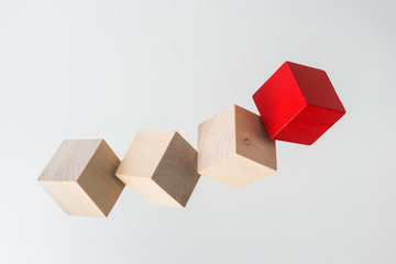 Business concept - Abstract geometric real floating wooden cube on grey background and it's not 3D...