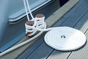 Cleat with line on the sailboat. Knot. Boat detail