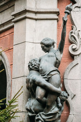 Riga, Latvia. Statues On Facade Of Old Cinema Building In Elizab