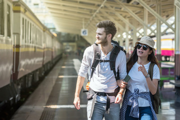 Multiethnic Travellers are walking and finding the train at the train station, Travel and transportation concept