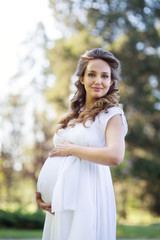 Fototapeta premium Young beautiful pregnant woman
