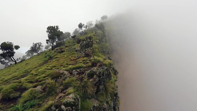 hiker coming down a hill in Simien mountains, Ethiopia