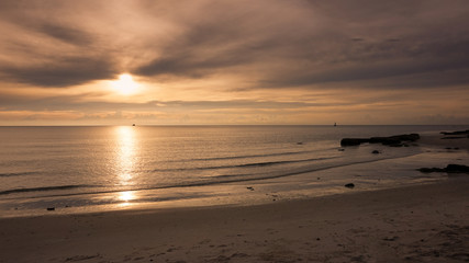 Sunlight shimmering  water surface on tropical beach