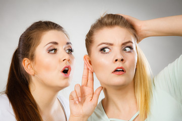 Two women telling gossip