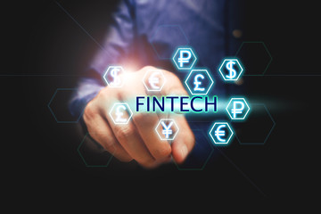 Financial technology concept, man pressing text fintech and currency.
