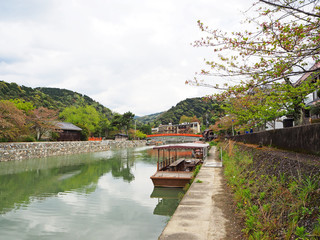 Fototapeta na wymiar Natural view of Uji river and wooden boat in spring season, Kyoto, Japan