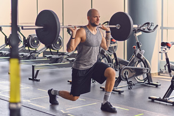 A man working out with dumbbells in a gym club.