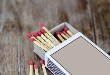 Box of matches on a wooden table, shot at close-up