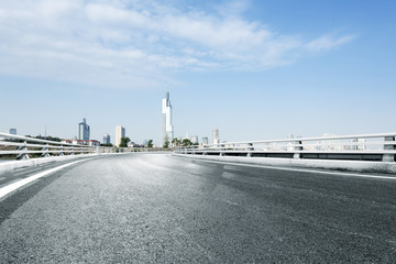 empty road with modern city