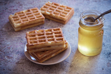 Baked waffles and organic sweet honey for breakfast