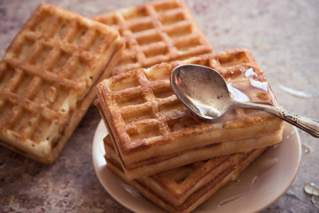 Baked waffles and organic sweet honey for breakfast