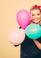 Fototapeta na wymiar Smiling crazy girl having fun with balloons.