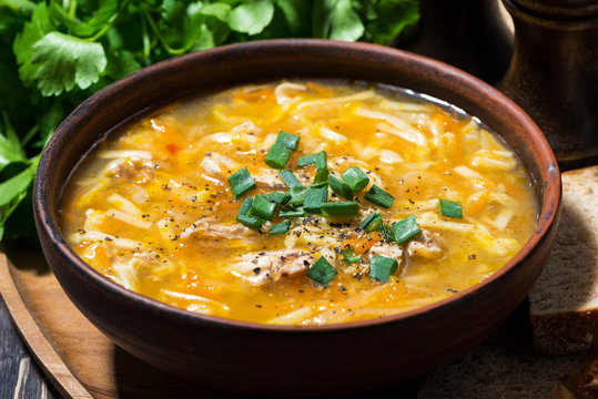 chicken soup with egg noodles in a bowl