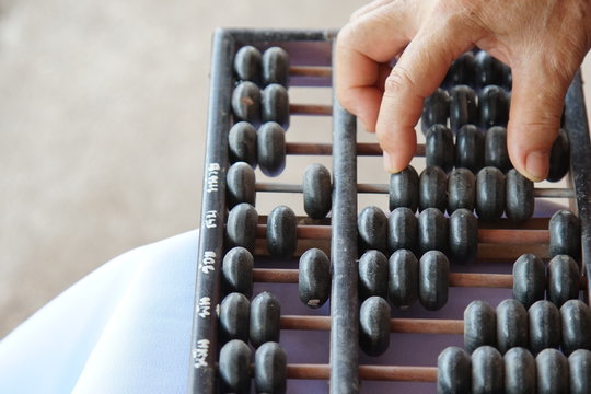 Old handle using old abacus for business