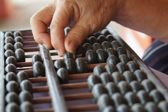 Old handle using old abacus for business