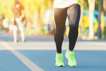 Runner legs between running in marathon competition in the city road.