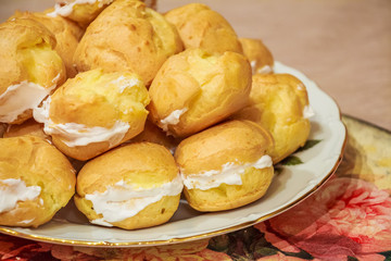 Close up of resh homemade profiteroles with cream