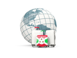 Luggage with flag of burundi. Three bags in front of globe