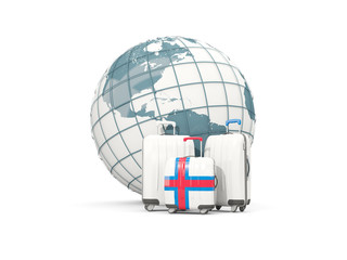 Luggage with flag of faroe islands. Three bags in front of globe