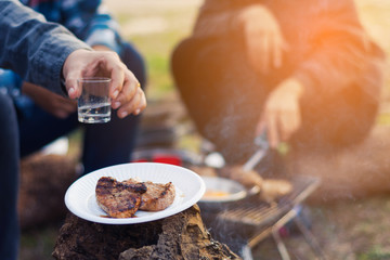 group friends cooking breakfast and drinking in weekend camping and feeling enjoying nature
