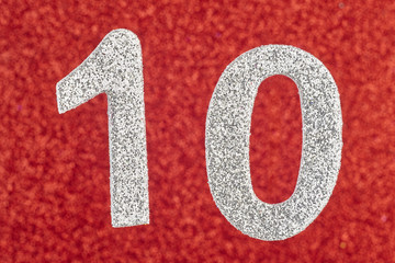 Number ten silver color over a red background. Anniversary.