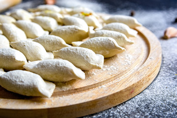 Fototapeta na wymiar Cooking traditional Russian dumplings vareniki