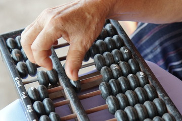 Old handle using abacus for business