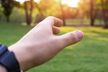 Praying Hands. Giving a helping hand, asking or offering help close-up shot of a Caucasian man in the park. hand with nature.
