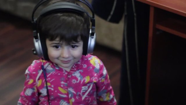 kid with headphones smiling