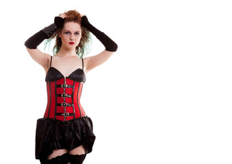 BDSM model in leather corset posing on white background in studio photo
