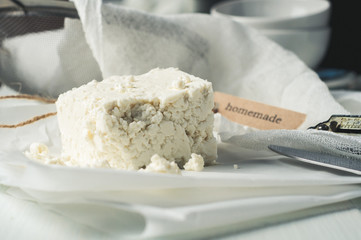 Fresh homemade cheese on a light table